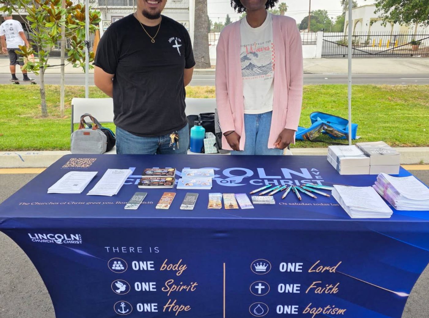 Printed fitted table cover and A-frame sign at an outdoor church event