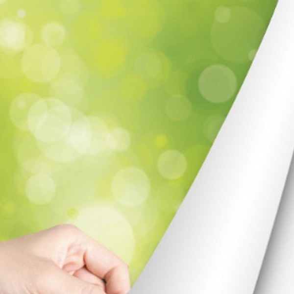 Printed adhesive vinyl being peeled from its backing